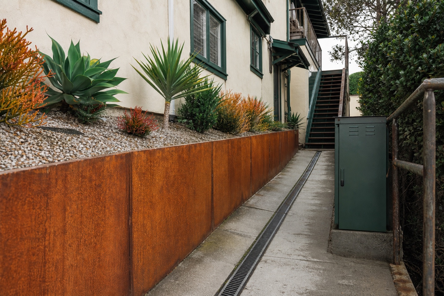 Coastal rental service side showing retaining, drainage, utility, and access constraints.