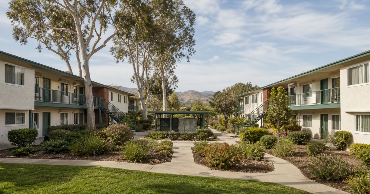 South Bay garden apartment complex in Chula Vista with broad courtyard and eucalyptus trees.