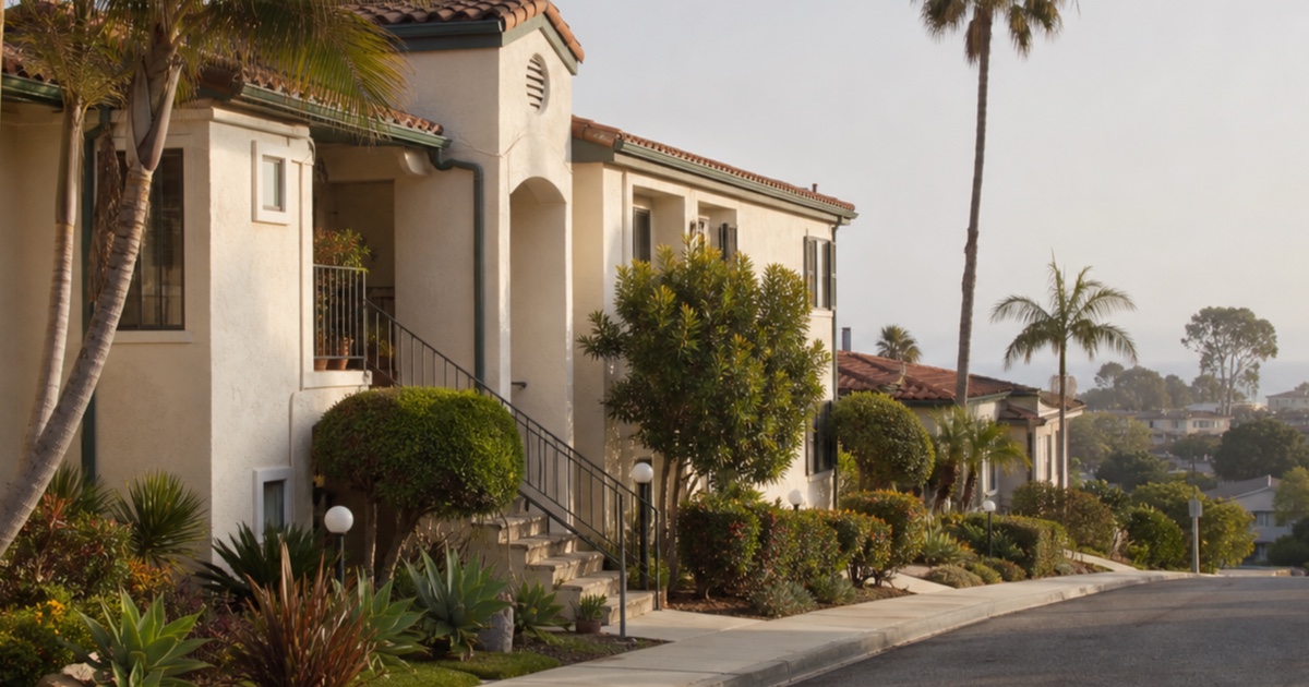 Coastal morning light on a landscaped multifamily rental street in Carlsbad.