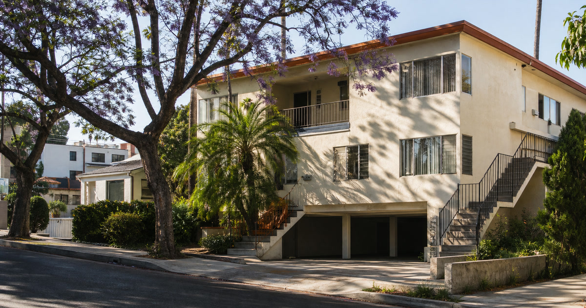 Classic City of Los Angeles dingbat apartment on a tree-lined residential street