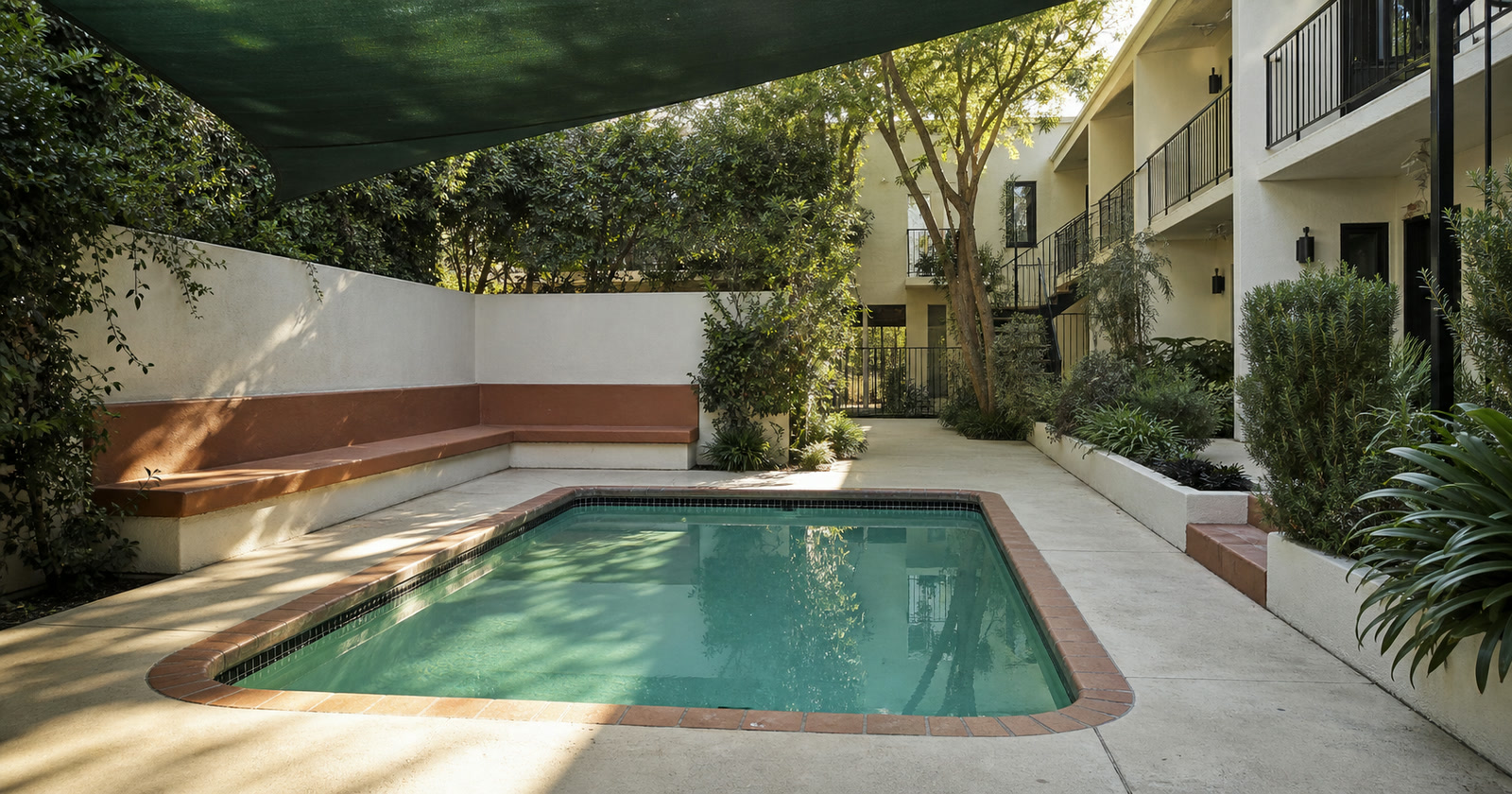 Unoccupied pool and courtyard seating at a West Hollywood apartment building