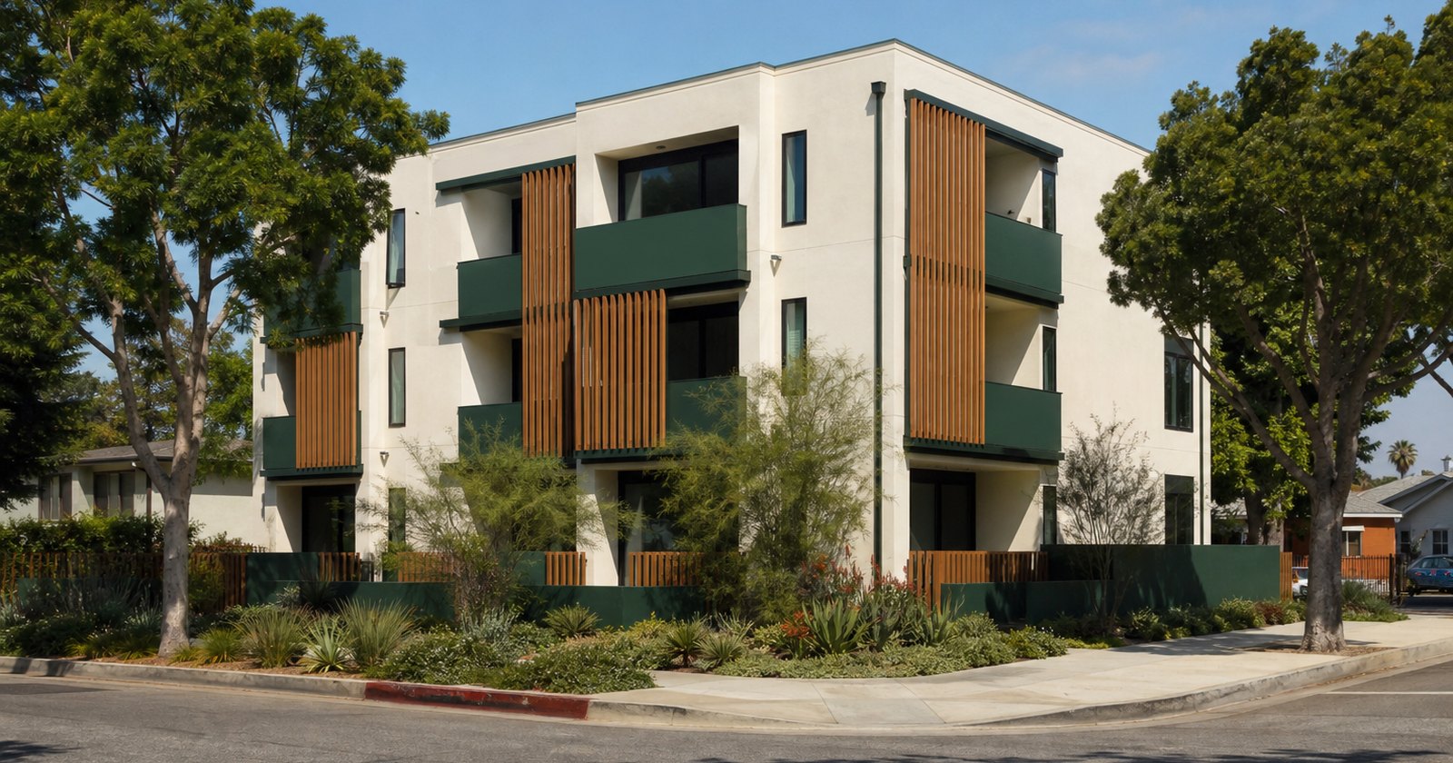 Recently built small California apartment property with simple modern materials and mature landscaping