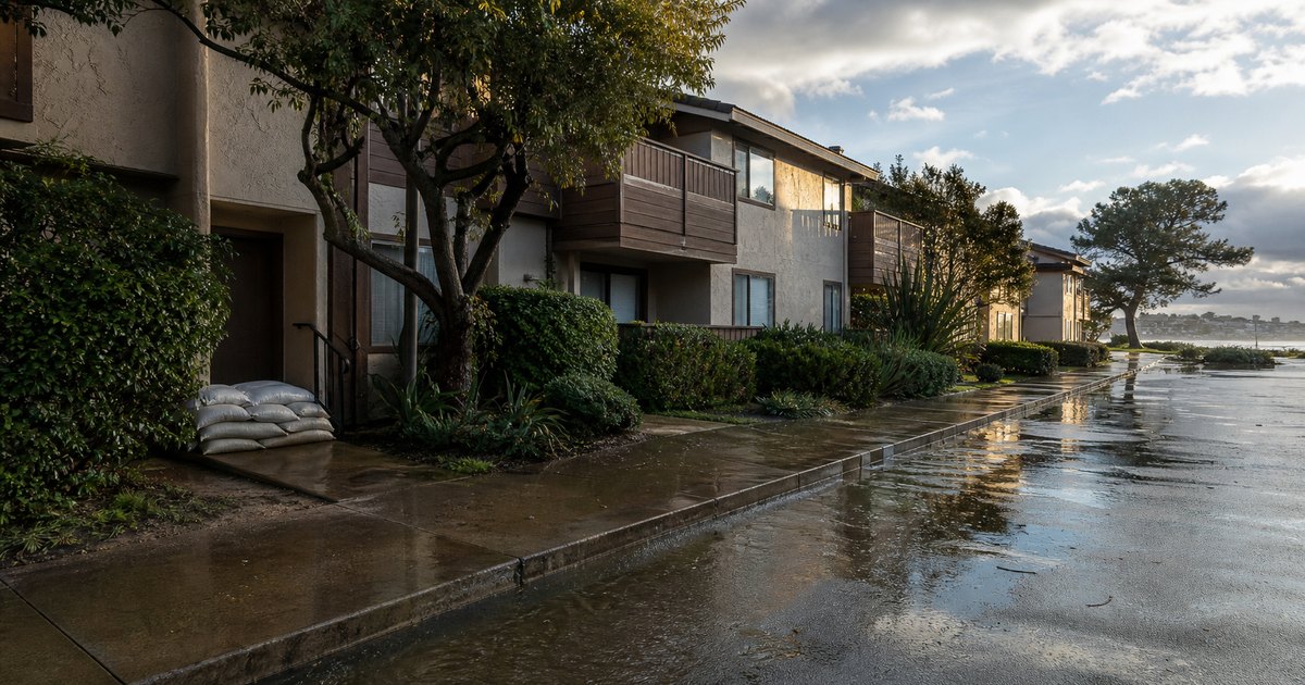Intact coastal California apartment property after a severe rainstorm with pooled water receding